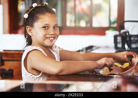 I dont mind helping around the house. Portrait of an adorable little girl washing dishes at home. Stock Photo