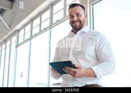 Were going to get you the car of your dreams. Shot of a car salesman using his digital tablet. Stock Photo