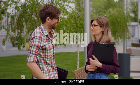 Two college students meeting and talking on campus, in a park.Having serious conversation Stock Photo