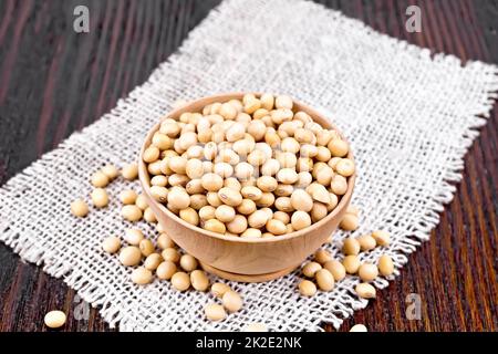 Soybeans in wooden bowl on dark board Stock Photo