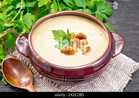 Soup puree of chanterelle in bowl on black board Stock Photo