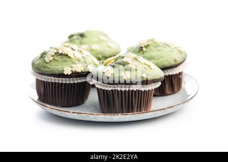 Sweet muffins with pistachio icing. Sweet dessert isolated on white background. Stock Photo