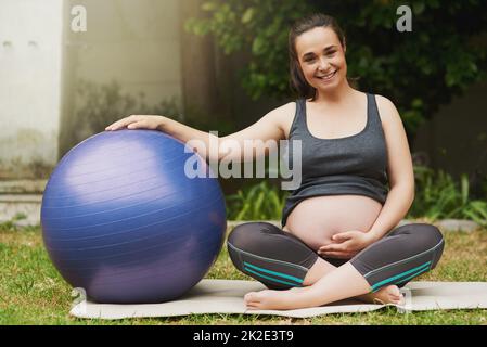 Fitness is a mothers best friend. Full length portrait of an attractive young pregnant woman exercising outside. Stock Photo