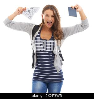 I cant wait to travel. A gorgeous young woman celebrating buying her plane tickets while isolated on a white background. Stock Photo