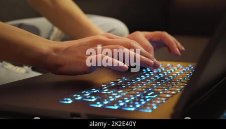Hands typing on Keyboard Late Night Working. Stock Photo