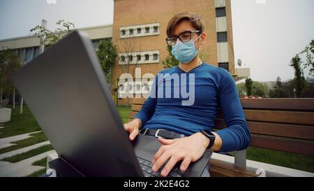 Serious male face , concentrated expression, portrait of pensive caucasian business man working on laptop. Young man working outdoor. Bad decisisons. Tired facial expression. Stock Photo