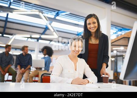 Shes a great mentor. Cropped portrait of two female designers working together in their office. Stock Photo