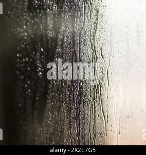 Rivulets and rain. Shot of drops of water on a smooth surface. Stock Photo