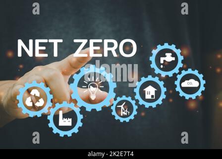 Businessman touching net zero save the eco world and reduce pollution virtual screen. virtual screen Business Technology Concept. Stock Photo