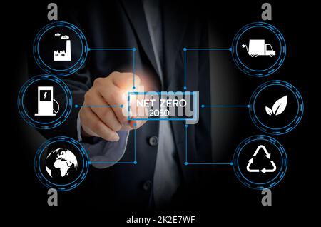 Businessman touching net zero save the eco world and reduce pollution virtual screen. virtual screen Business Technology Concept. Stock Photo