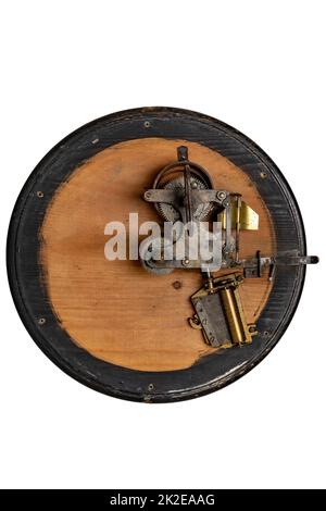 Inside the antique revolving Christmas tree stand the mechanism for playing two Christmas carols consisting of roller mechanism with music box and spring drive. Clipping path. Stock Photo