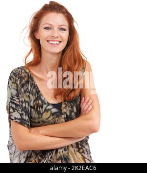 Lighthearted, fun and fresh. Confident red-haired woman smiling with arms folded, isolated on white - copyspace. Stock Photo