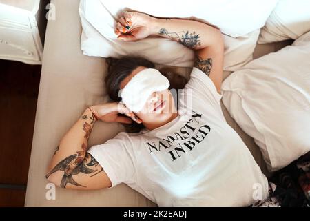 Beautiful woman with tattoo sleeping in bed at home with cover mask Stock Photo - Alamy
