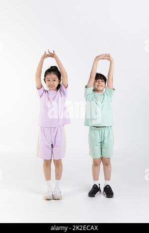 Korean boy and girl fitness and exercise concept in white background  practicing gymnastics Stock Photo