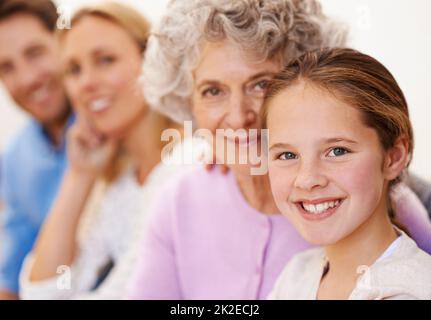 Quality time together. Portrait of a cheerful multi generational family smiling together. Stock Photo