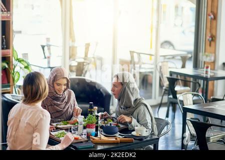 Saturday is catch up day. Shot of a group of women getting together for lunch in a cafe. Stock Photo