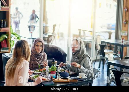Eat up and catch up. Shot of a group of women getting together for lunch in a cafe. Stock Photo