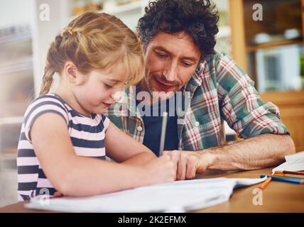 Dads always around to lend a hand with homework. Cropped shot of a father helping his daughter with her homework. Stock Photo