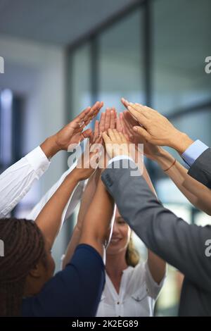 Go team. Shot of a group of unrecognizable businesspeople with their hands in a huddle. Stock Photo