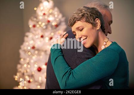 All I want for Christmas is you. Cropped shot of a happy couple embracing at Christmas. Stock Photo