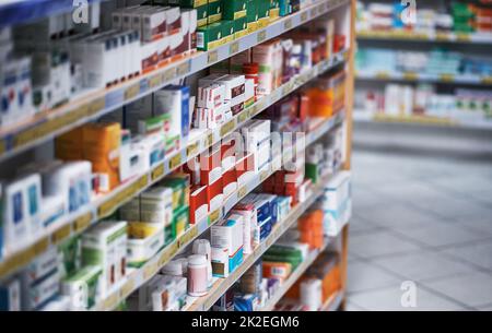 Broad spectrum of brands to get your better. Shot of shelves stocked with various medicinal products in a pharmacy. Stock Photo