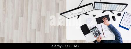 Young Businessman Calculating Bill In Office Stock Photo