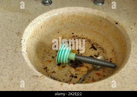 https://l450v.alamy.com/450v/2k2ej22/using-a-plastic-kitchen-pump-to-unclog-the-kitchen-sink-2k2ej22.jpg