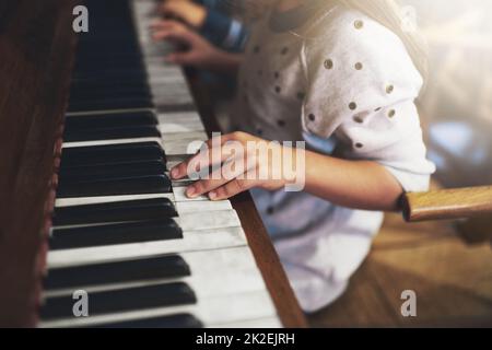 Pianos unlock the keys to childhood talent. Cropped shot of a little girl playing the piano. Stock Photo