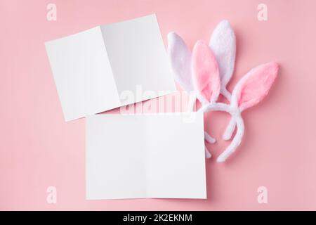 Easter mockup with decorative rabbit ears. Delicate Easter blanks for design on pink background. Stock Photo