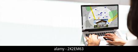 Businesswoman Working With Spreadsheet On Laptop Stock Photo