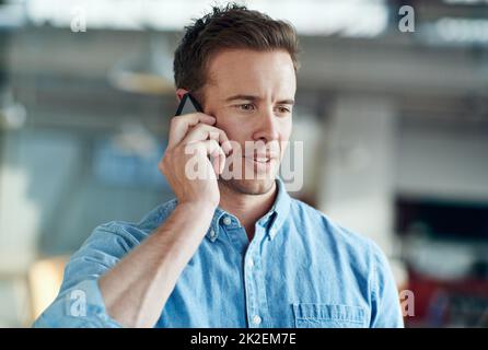 Hes a model employee. a casually-dressed businessman standing in his office. Stock Photo