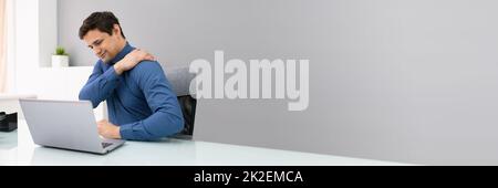 Mature Businessman Suffering From Shoulder Pain Stock Photo