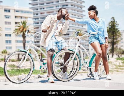Black man, kiss woman hand and outdoor park holiday in miami. Couple on romantic summer date, cycling in city street and happy girlfriend. Young Stock Photo