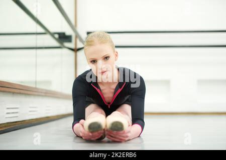 Ballet is a great way to discipline your body. Shot of a young woman practising ballet. Stock Photo