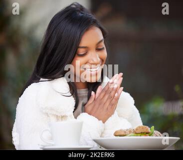 Who doesnt love good food. Shot of a young woman having brunch. Stock Photo