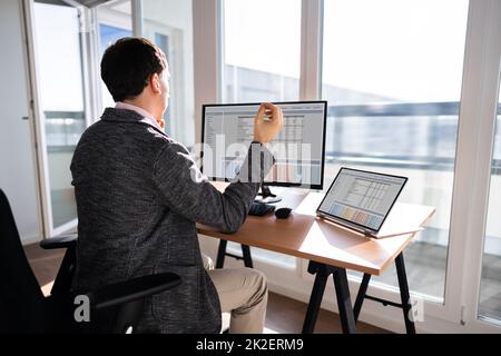 Young Businessman Sitting On Desk Meditating Stock Photo