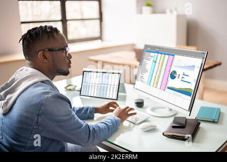 African American Auditor Using Electronic Spreadsheet Stock Photo