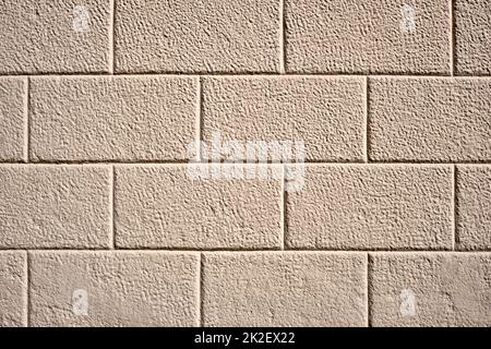 Background from a wall with rectangular beige stone slabs Stock Photo