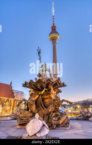 The famous TV Tower and the Neptune fountain in Berlin at twilight Stock Photo