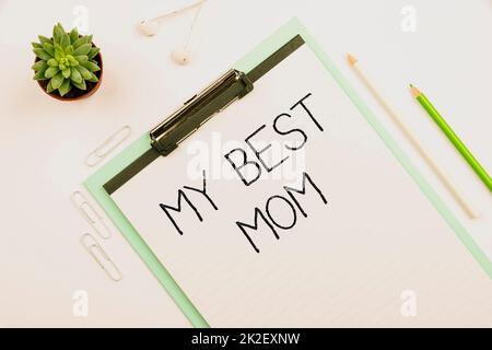 Conceptual caption My Best Mom. Concept meaning Admire have affection good feelings love to your mother Multiple Assorted Collection Office Stationery Photo Placed Over Table Stock Photo