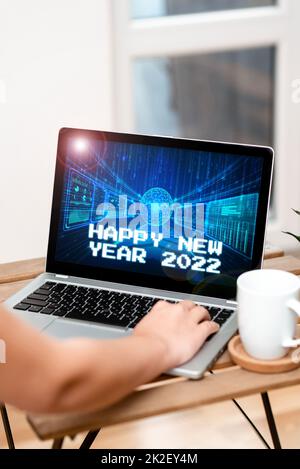 Text caption presenting Happy New Year 2022. Business overview celebration of the beginning of the calendar year 2022 Both Hands Typing On Laptop Next To Cup And Plant Working From Home.