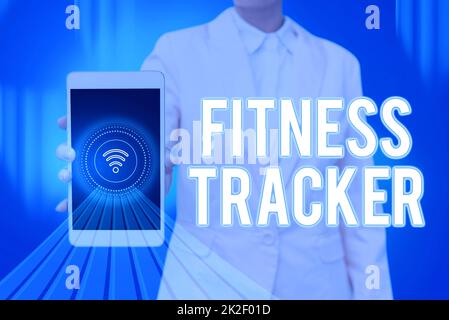 Hand writing sign Fitness Tracker. Business idea device that records a persons daily physical activity Lady Pressing Screen Of Mobile Phone Showing The Futuristic Technology Stock Photo