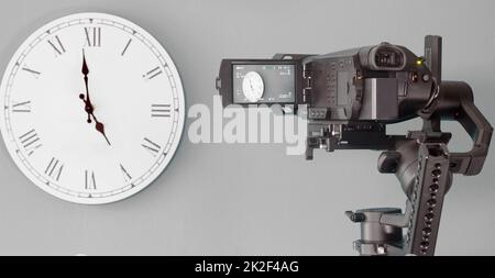 The camera on the gimbal shoots the clock Stock Photo
