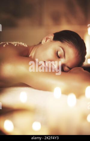 Allow yourself to be where you are. Cropped shot of a young woman getting an exfoliating treatment at the spa. Stock Photo