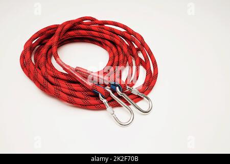 Red climbing rope on white background Stock Photo
