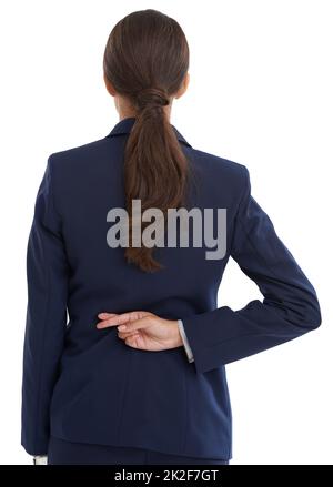 Going back on her word. Rear view shot of a businesswoman with her fingers crossed behind her back in studio. Stock Photo