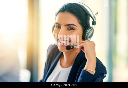 Im always here to help. Cropped portrait of an attractive young female customer care agent at work in her office. Stock Photo