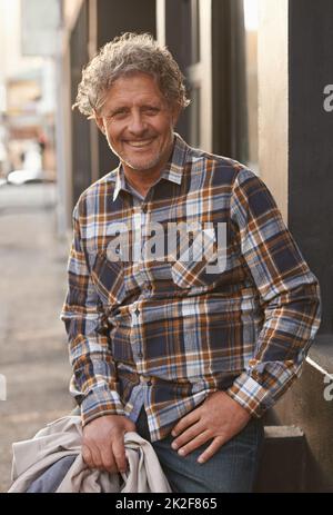 Style is timeless. Portrait of a friendly-looking middle aged man outside. Stock Photo