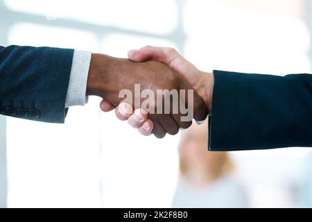 The deal is done. Closeup shot of two unrecognizable businessmen shaking hands in an office. Stock Photo
