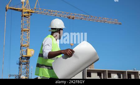 African American architect compares building to drawings Stock Photo